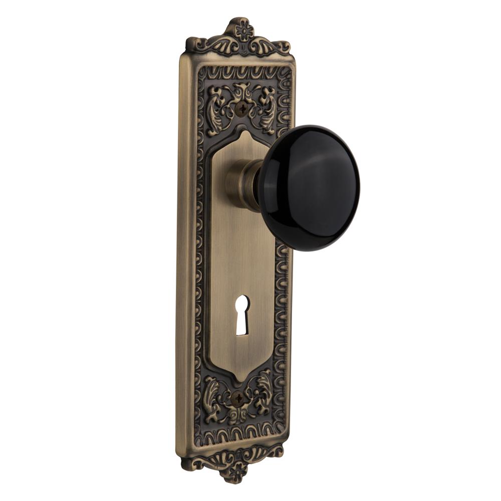 Nostalgic Warehouse EADBLK Mortise Egg and Dart Plate with Black Porcelain Knob with Keyhole in Antique Brass